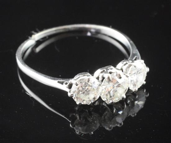 A platinum three stone diamond ring, size V.